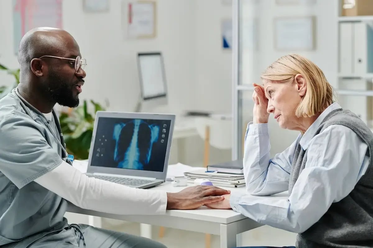 young-doctor-comforting-mature-female-patient-with-2025-03-15-20-56-57-utc