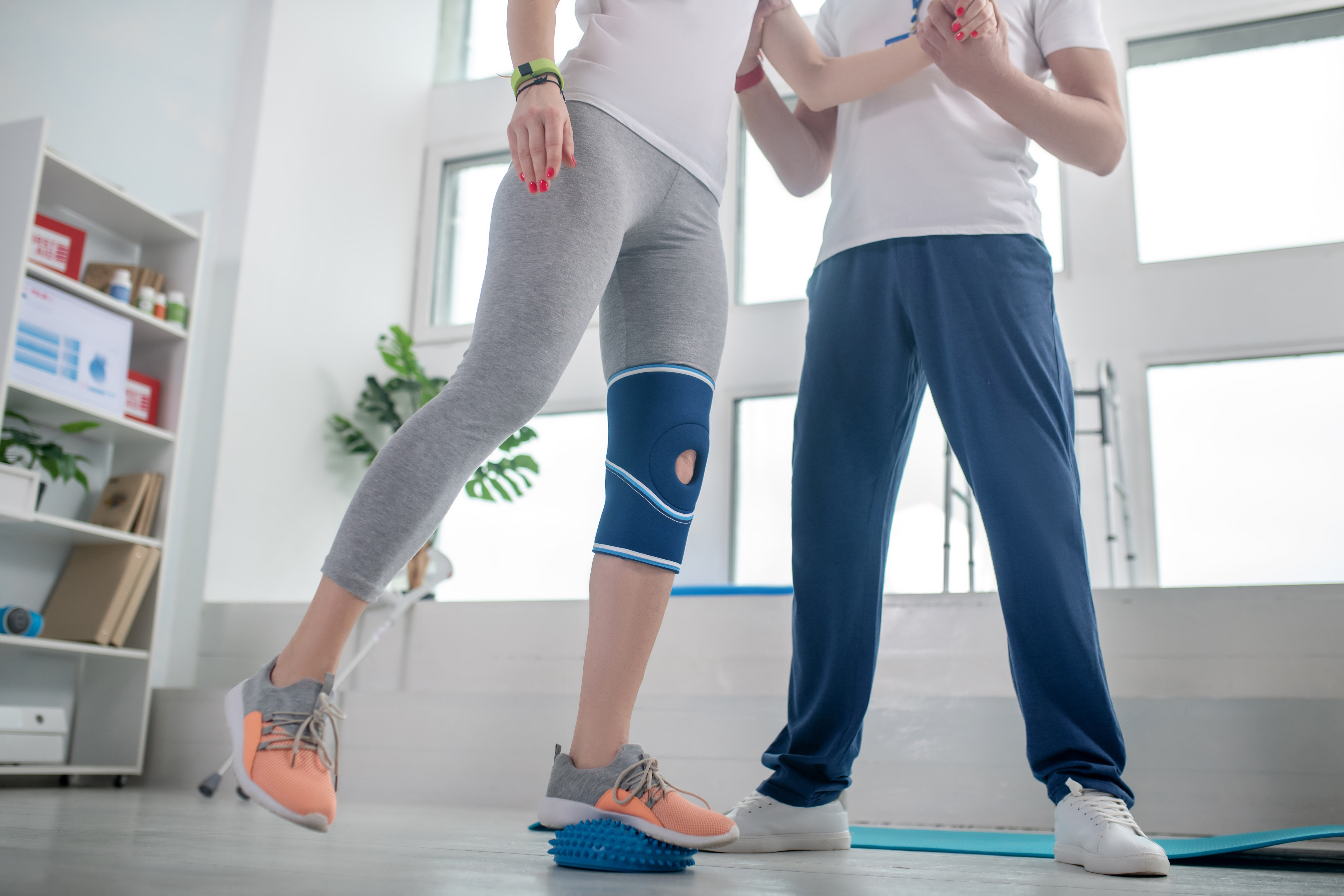 male-physiotherapist-assisting-female-patient-with-2024-10-16-22-53-19-utc