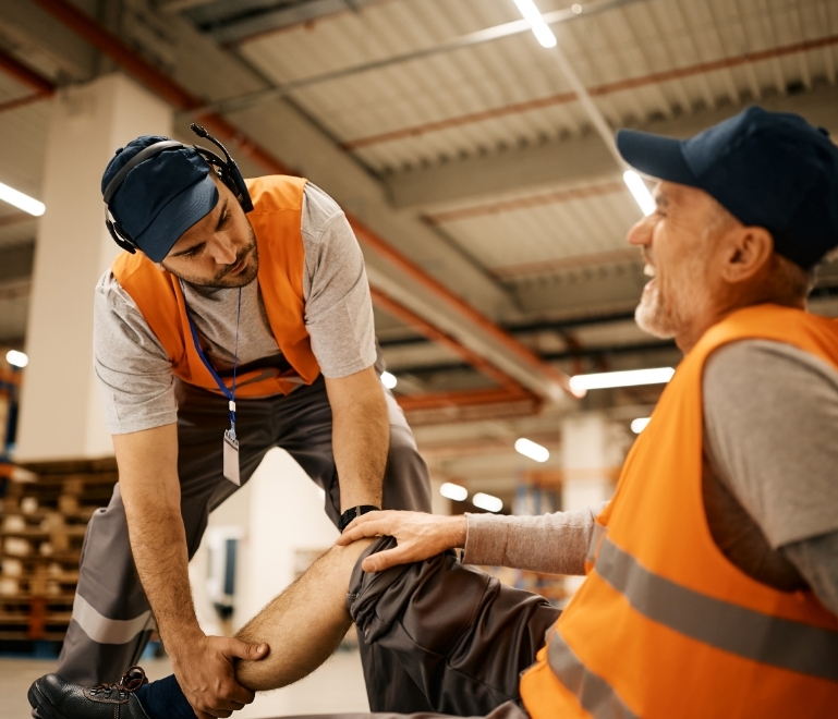 warehouse-worker-helping-his-mature-coworker-who-i-2024-12-13-20-24-45-utc